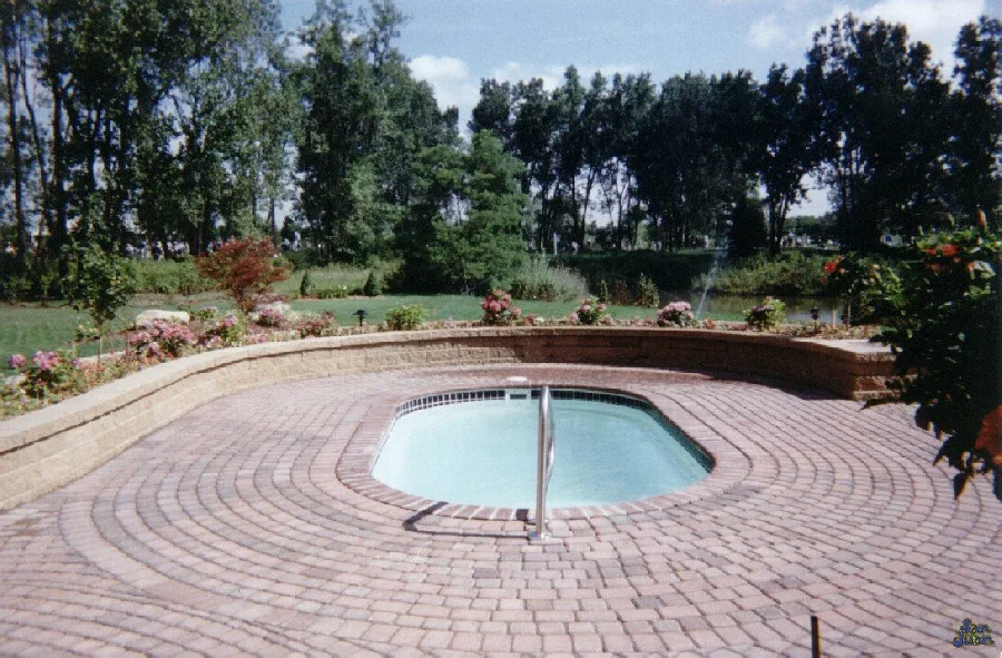 Lakeside fiberglass pool installed in a backyard