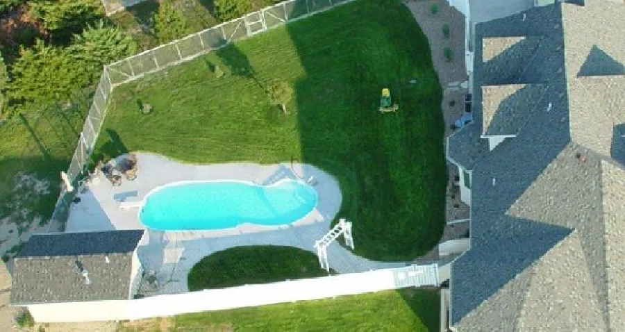 Oasis fiberglass pool installed in a backyard