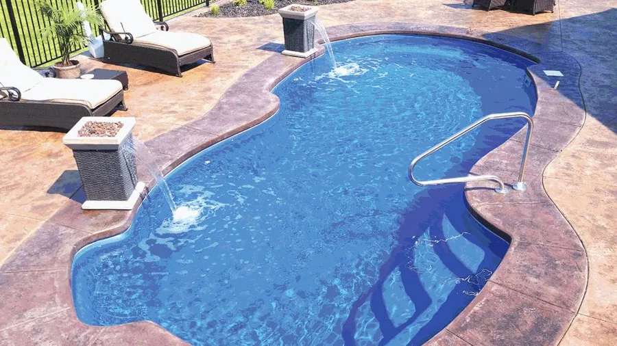 Cayman fiberglass pool installed in a backyard