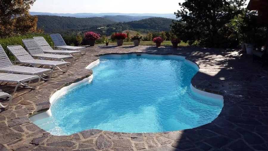 Grand Cayman fiberglass pool installed in a backyard
