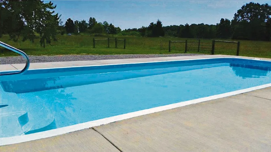 Lakeside fiberglass pool installed in a backyard