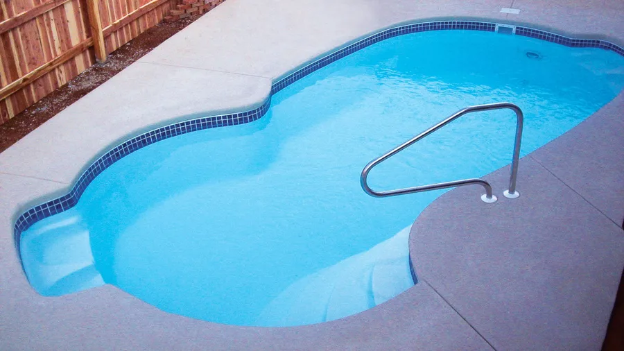 Nassau fiberglass pool installed in a backyard