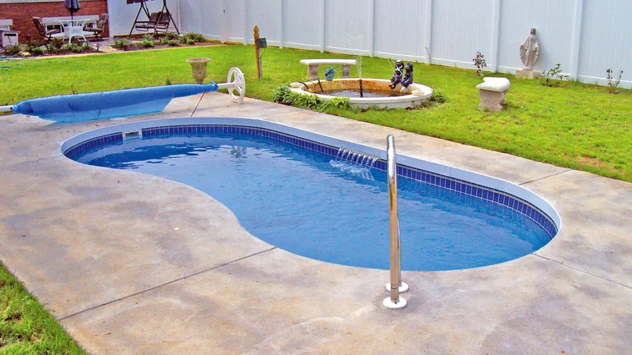 Shoreline fiberglass pool installed in a backyard